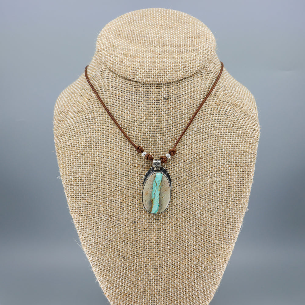 Ribbon turquoise sterling silver pendant on leather cord on a mannequin