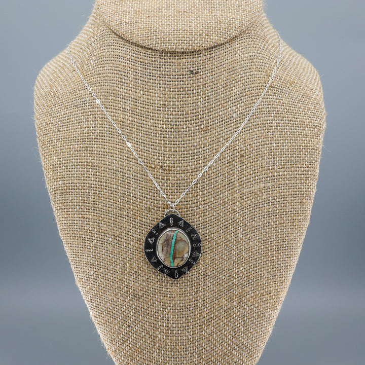 one of a kind ribbon turquoise sterling silver necklace on a mannequin