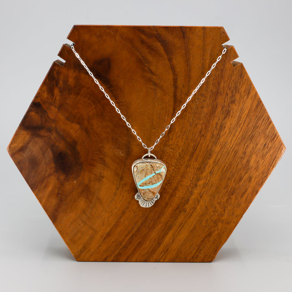 ribbon turquoise pendant one-of-a-kind necklace on a wood display