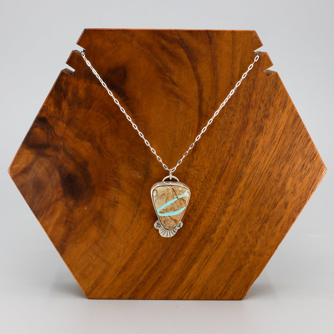ribbon turquoise pendant one-of-a-kind necklace on a wood display
