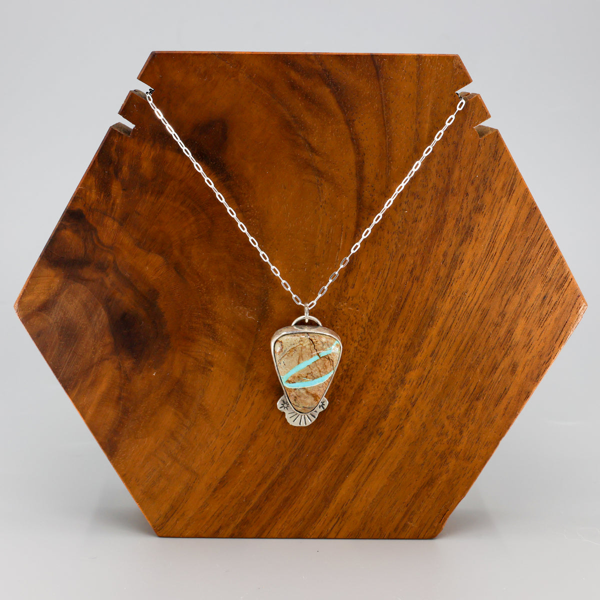 ribbon turquoise pendant one-of-a-kind necklace on a wood display