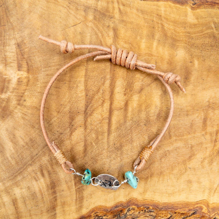 Sagittarius bracelet - sterling silver, turquoise, leather on a wood background