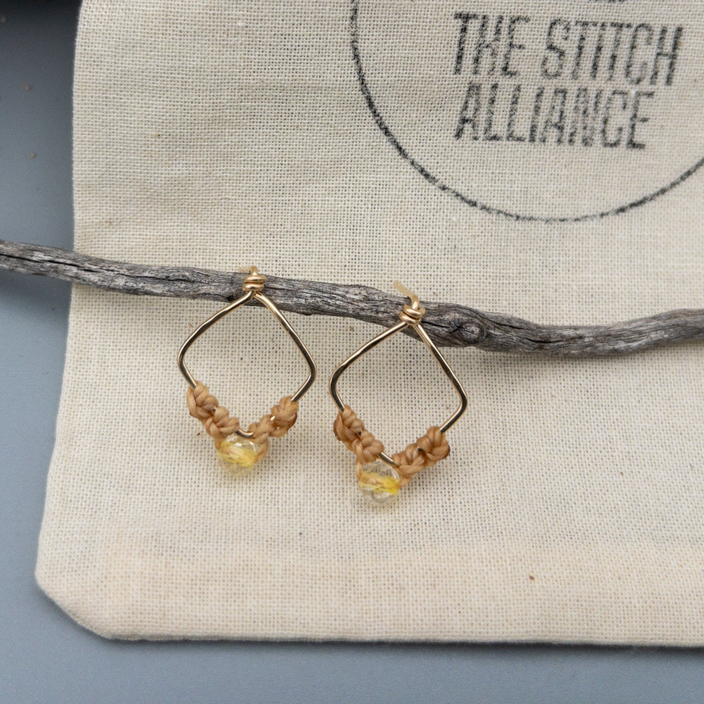 Sagittarius citrine earrings macrame gold fill shown on a muslin bag