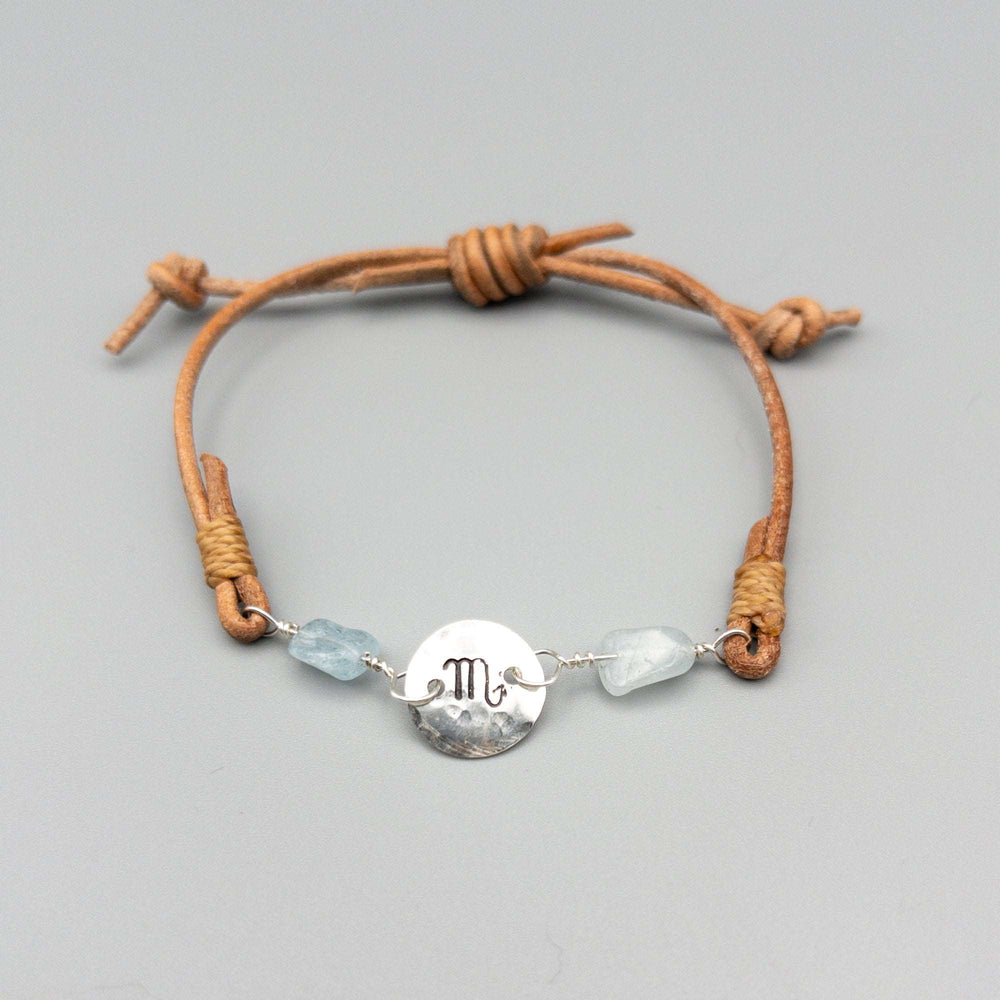 Scorpio zodiac sterling silver and  leather bracelet with aquamarine beads on a gray background