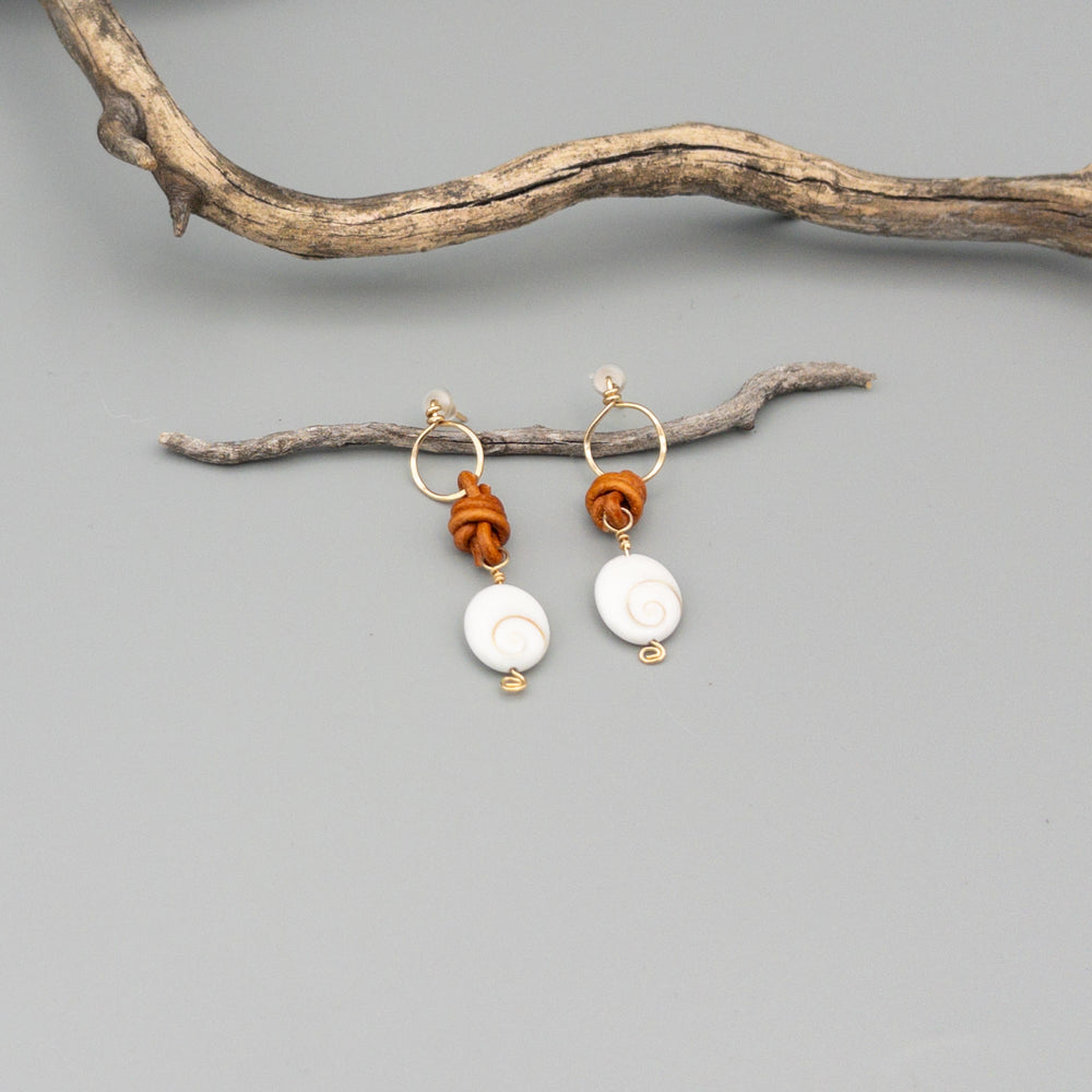Shiva Shell, Leather, and Gold Fill Handmade Earrings on a gray background