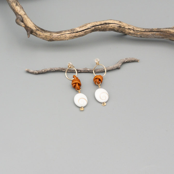 Shiva Shell, Leather, and Gold Fill Handmade Earrings on a gray background