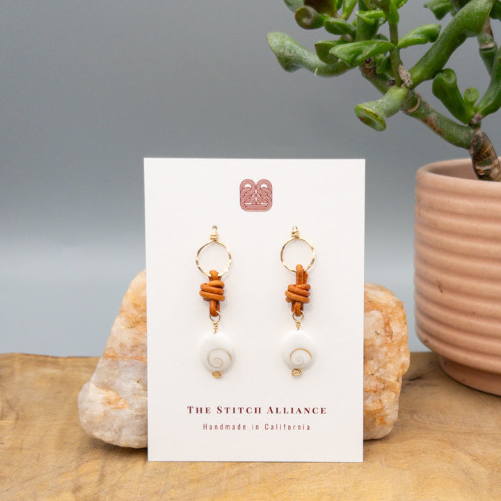 Shiva Shell, Leather, and Gold Fill Handmade Earrings on a white card