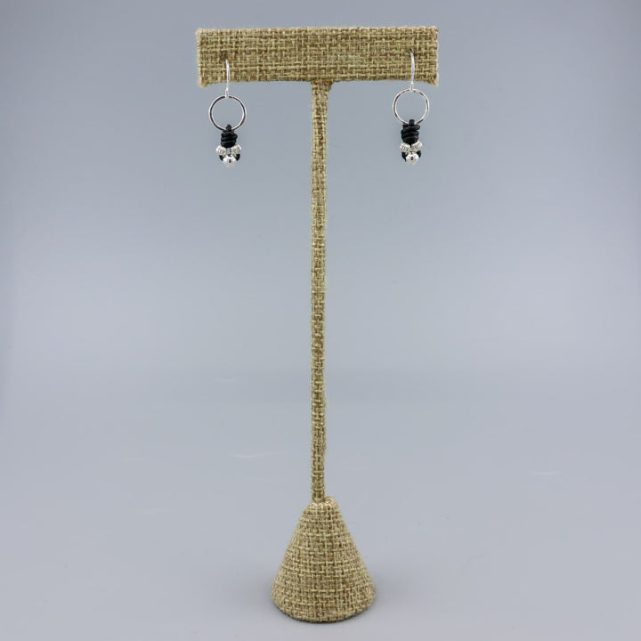 handmade sterling silver and leather knotted earrings on a linen hanger