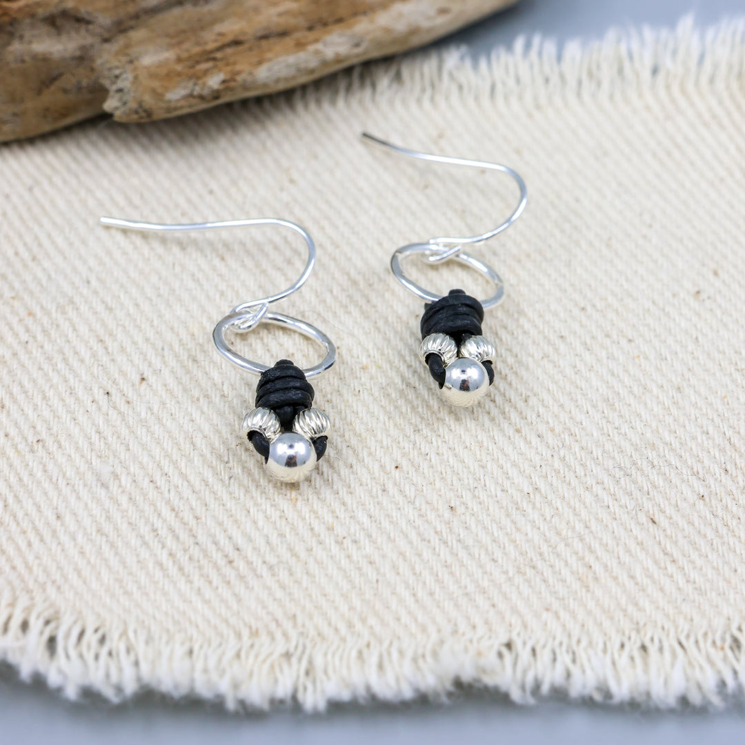 handmade sterling silver and leather knotted earrings detail view