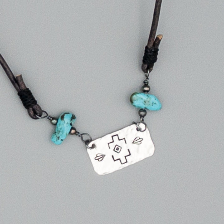 Stamped silver turquoise and leather necklace close up