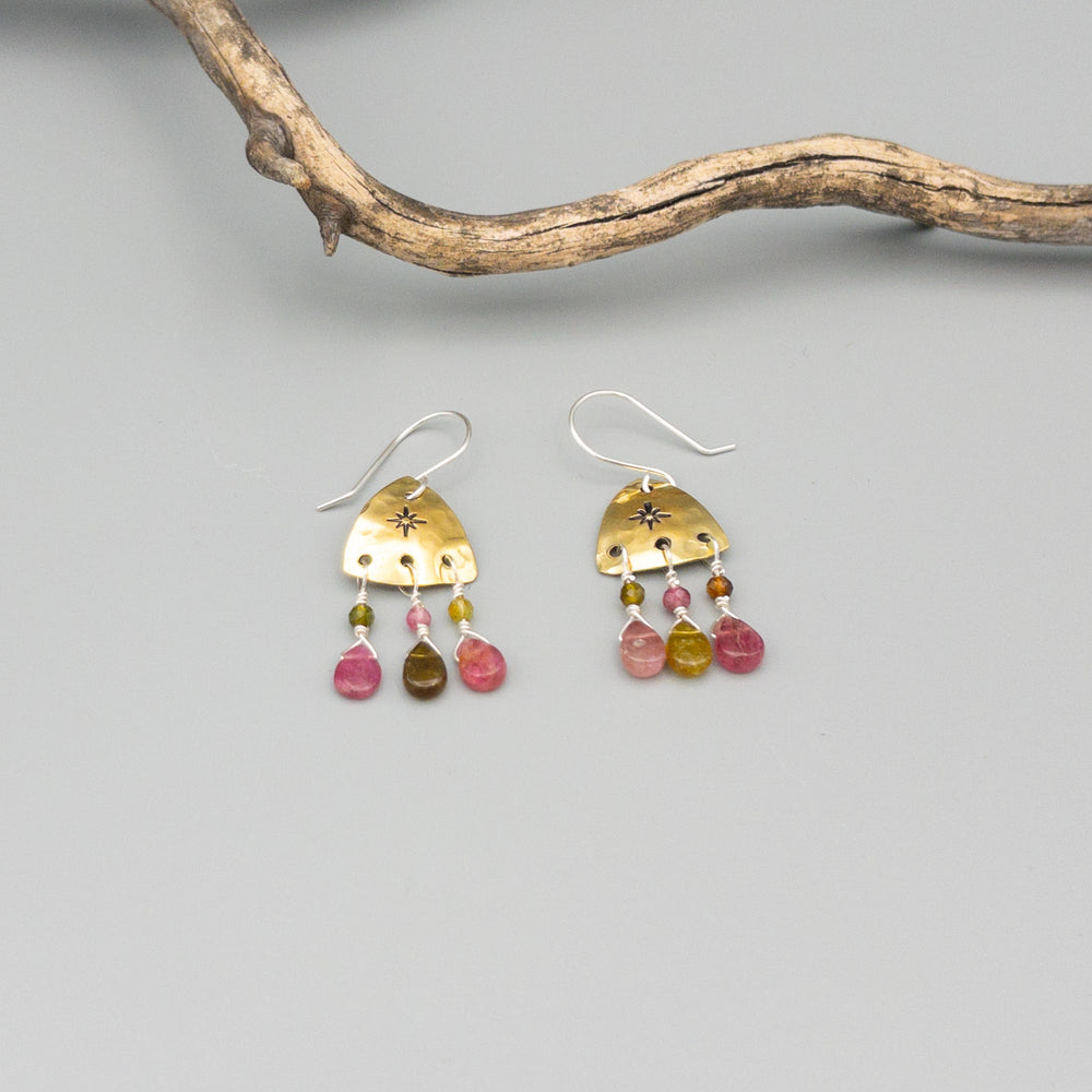 hand stamped brass earrings with tourmaline beads and sterling silver ear wires on a gray background