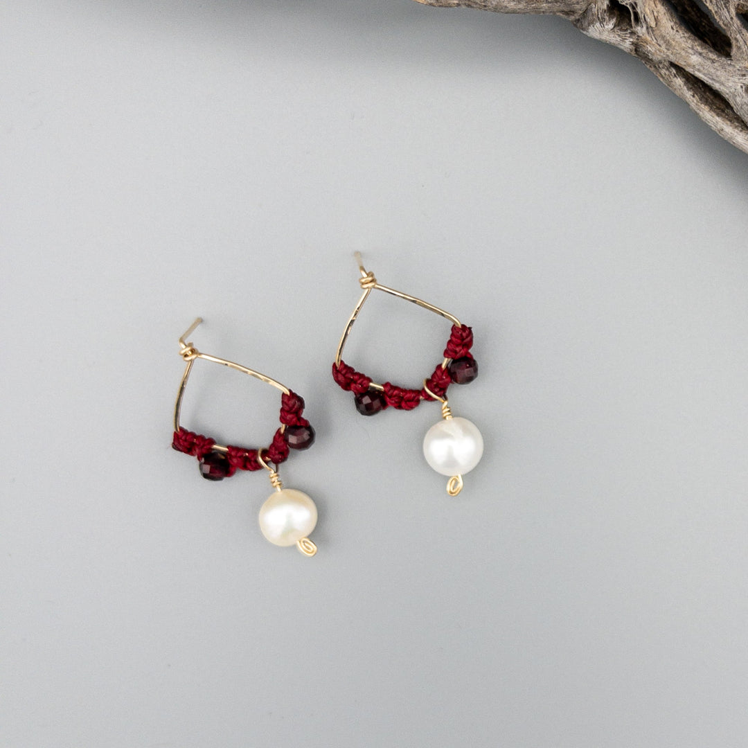 Garnet and freshwater pearl gold filled macrame earrings on a gray background