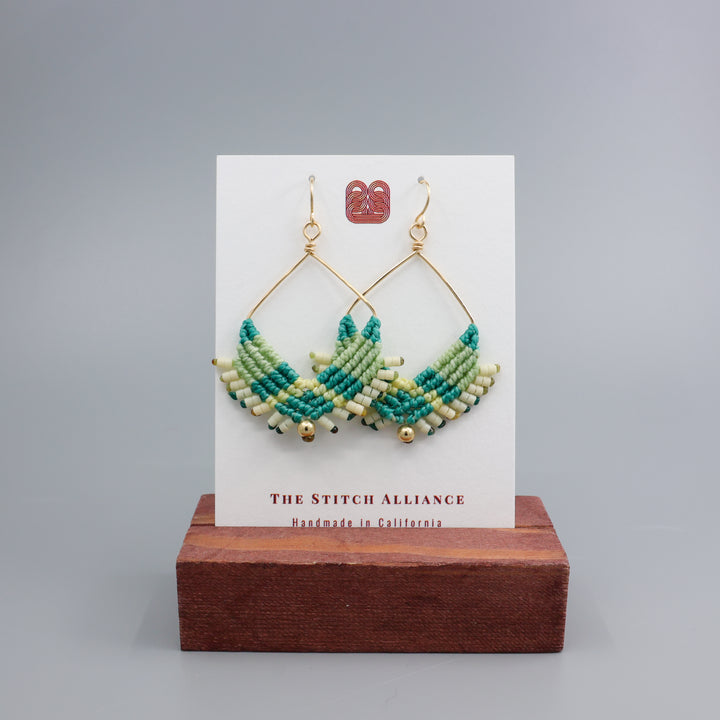 handmade macrame statement hoop earrings with gold fill wire on a white display card