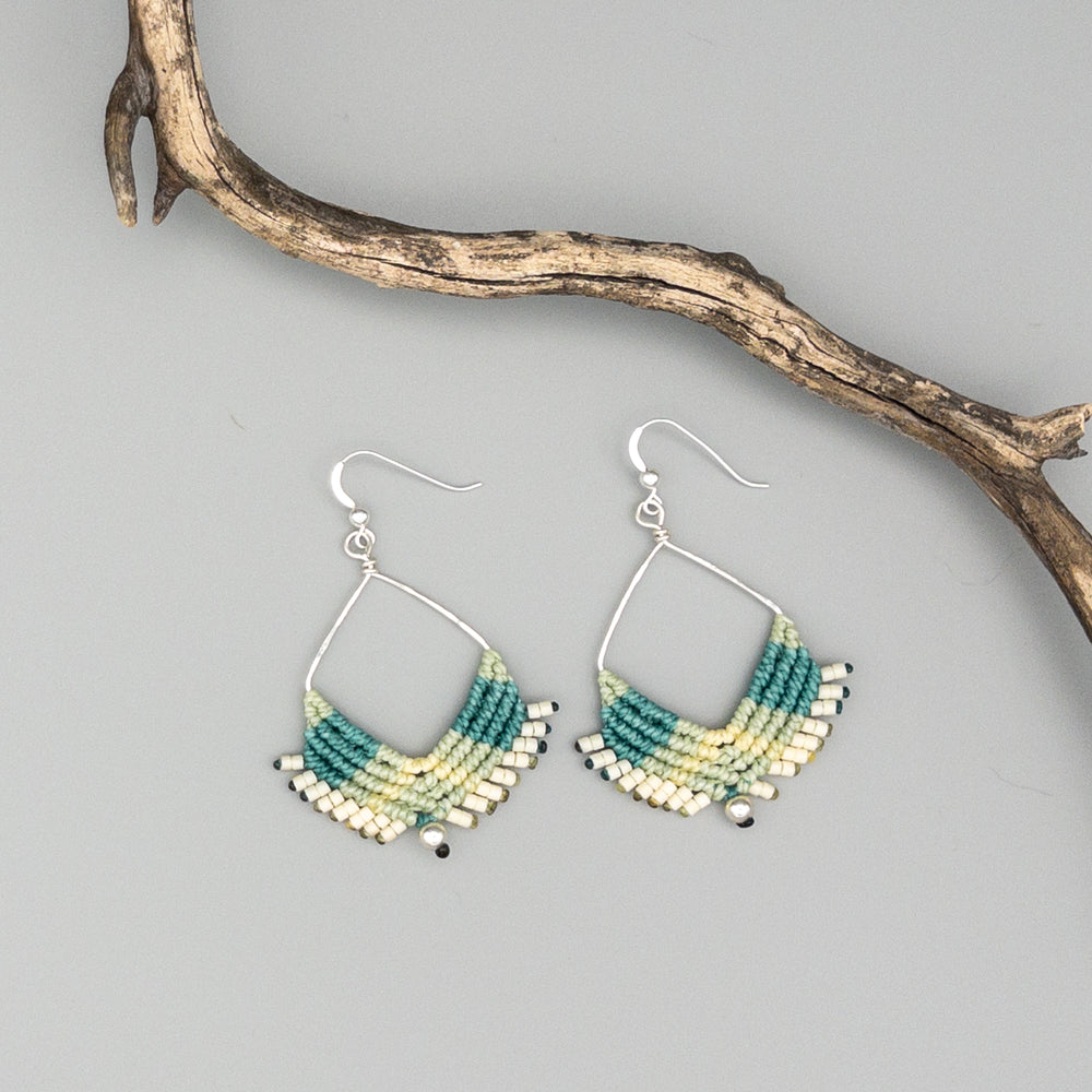 sterling silver square hoop macrame earrings in greens on a gray background