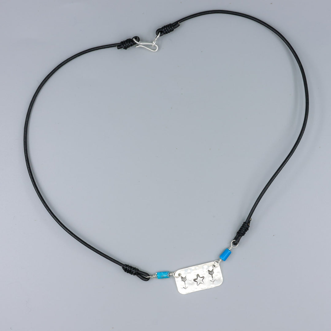 Handstamped star and arrow choker with turquoise beads overhead view