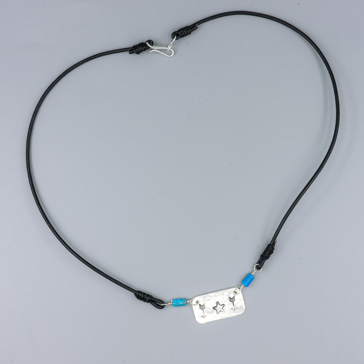 Handstamped star and arrow choker with turquoise beads overhead view