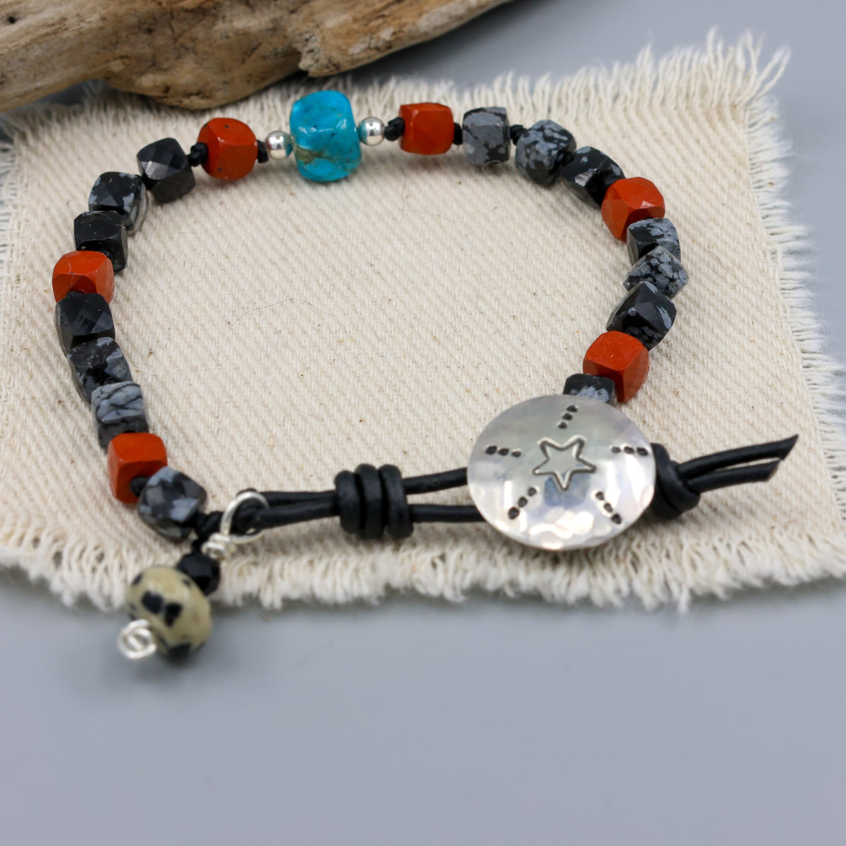 handmade turquoise, jasper, and larvikite beaded bracelet with a star-stamped sterling silver button closure 