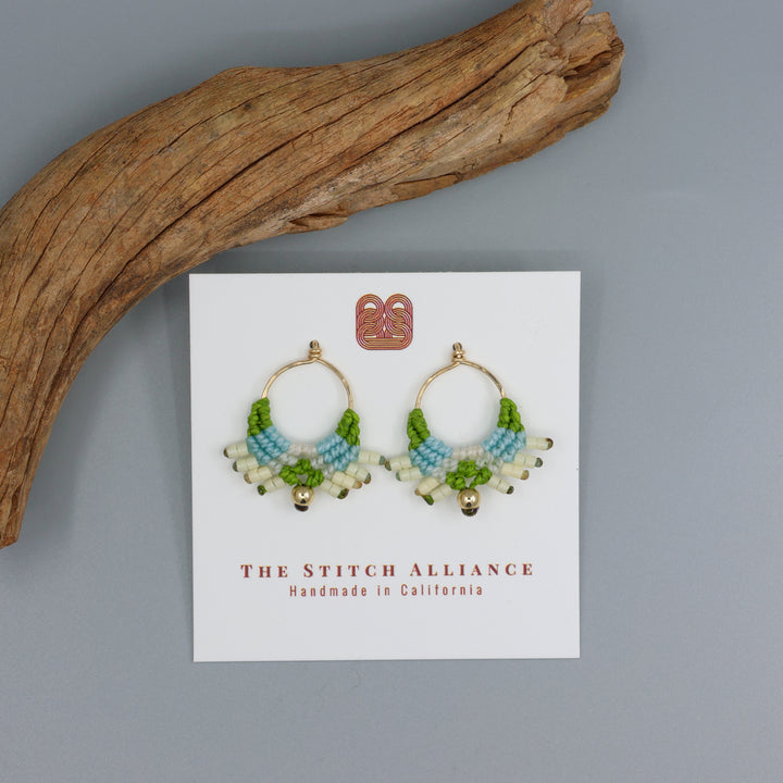 handmade gold-filled macrame earrings in blue, green, and natural on a white card