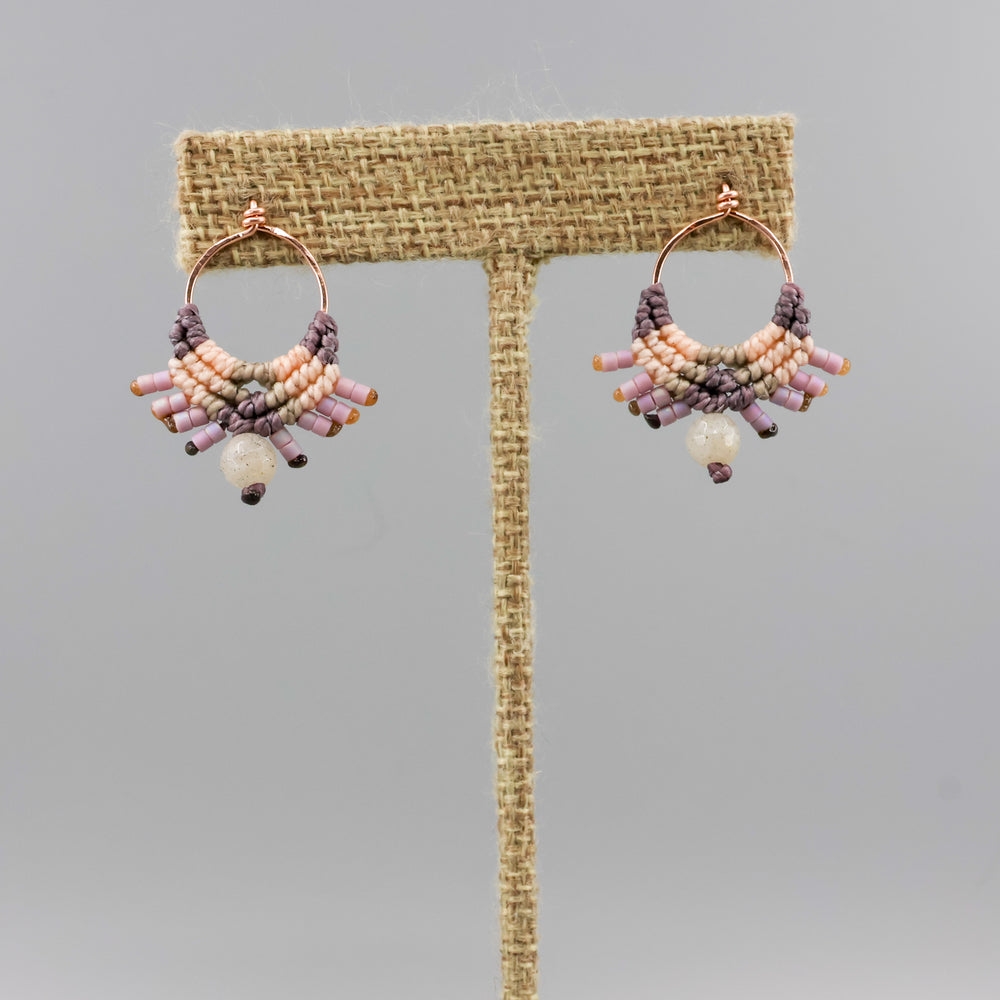 handmade macrame earrings in rose gold, peach and dusty purple with a labradorite bead on a linen hanger