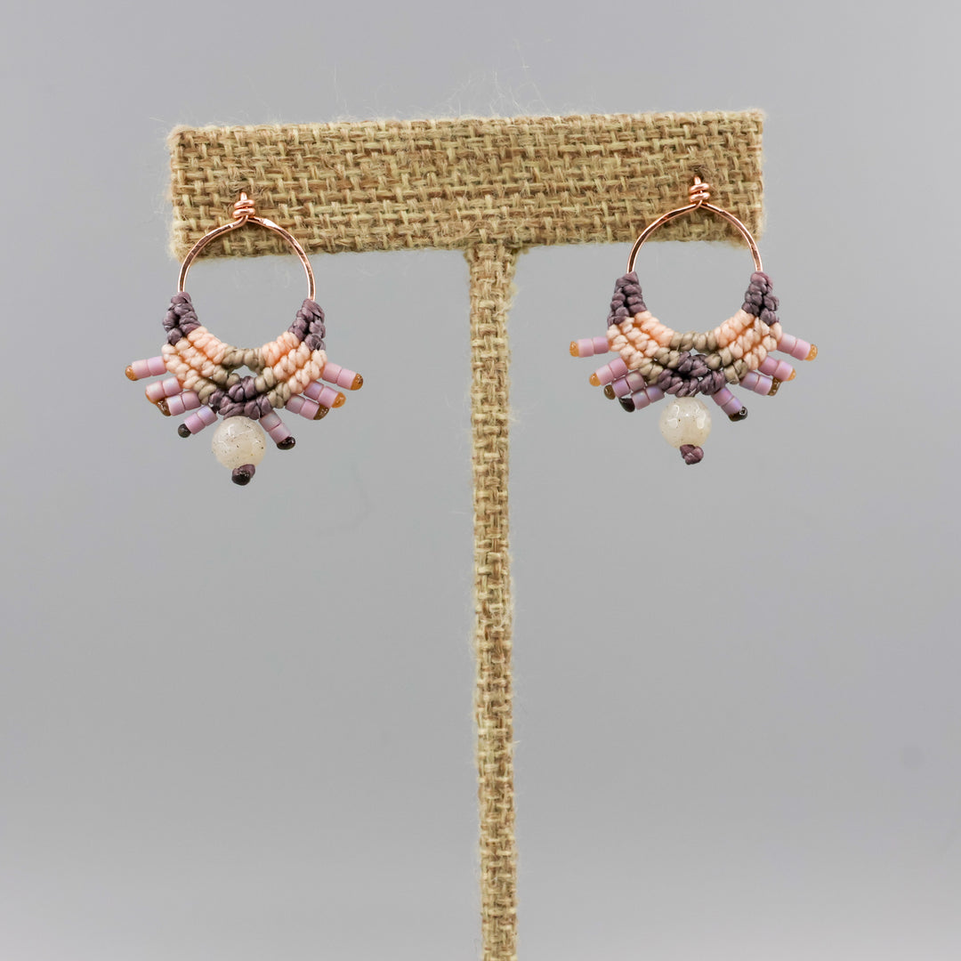 handmade macrame earrings in rose gold, peach and dusty purple with a labradorite bead on a linen hanger