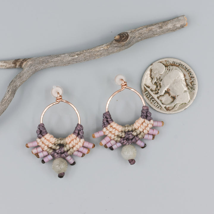 handmade macrame earrings in rose gold, peach and dusty purple with a labradorite bead with coin for size comparison