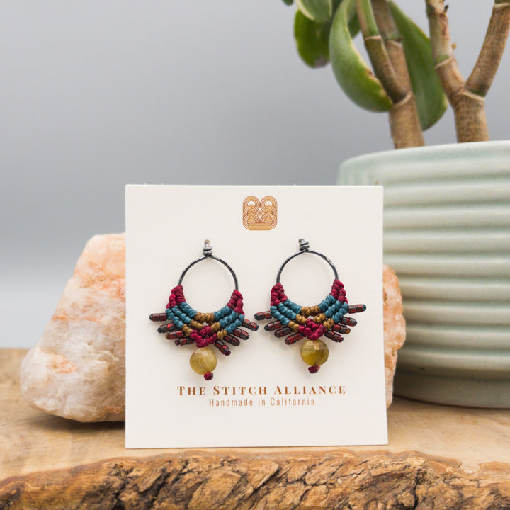 handmade macrame earrings in deep red, teal, and gold with golden tiger's eye bead on oxidized sterling silver loops