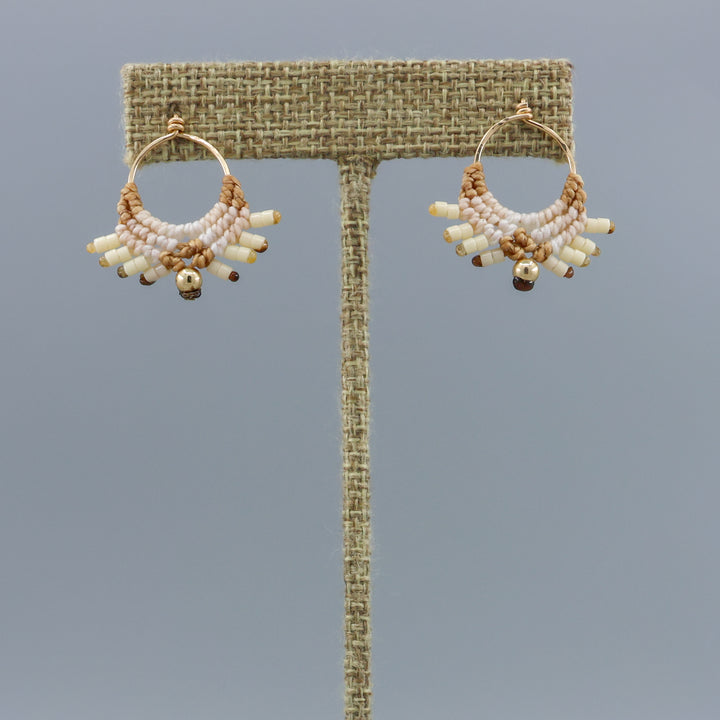 handmade macrame earrings with gold fill wire in tan colors on a linen hanger