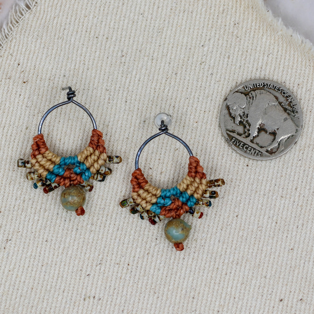 handmade macrame earrings with coin for size comparison