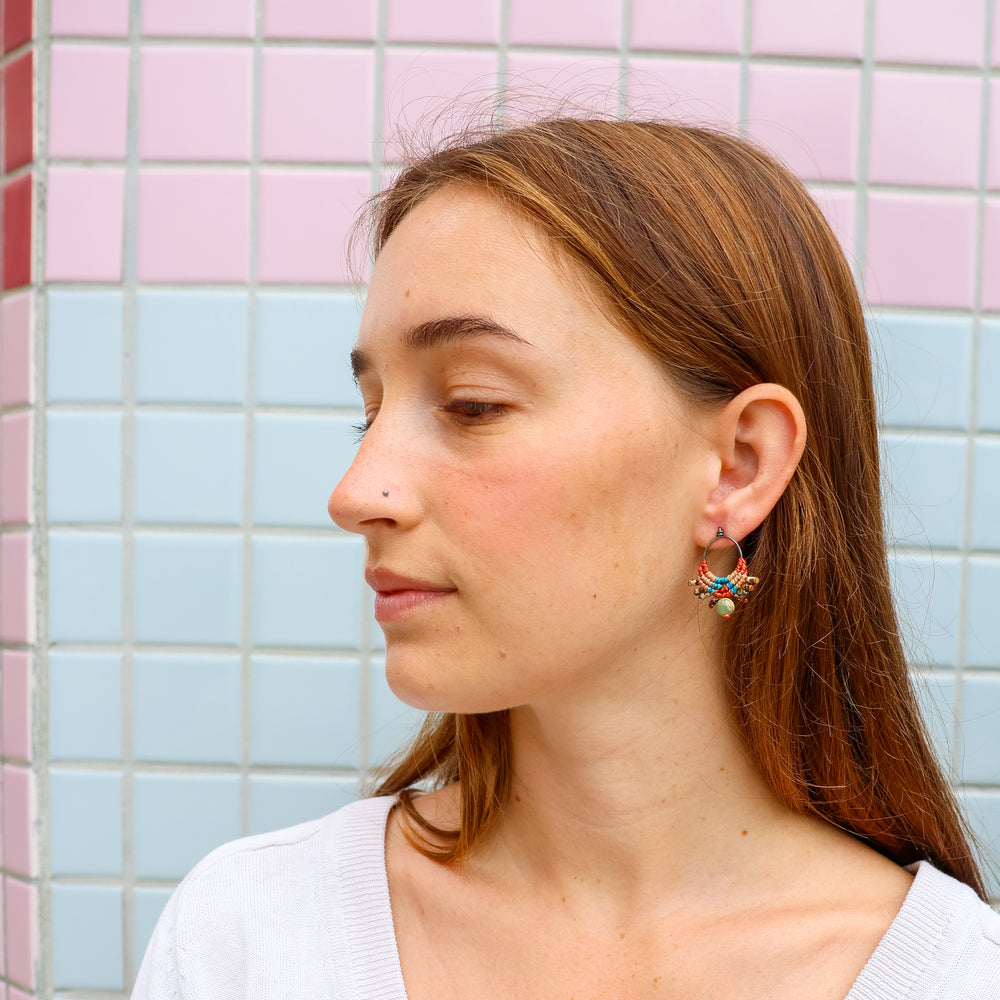handmade macrame drop earrings with aqua terra jasper bead worn on a model