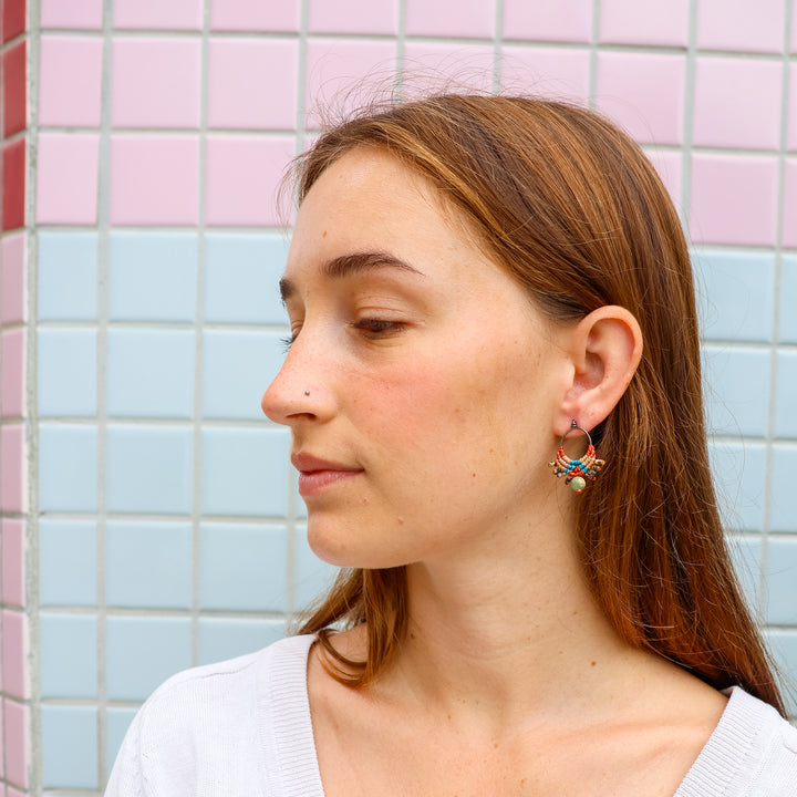 handmade macrame drop earrings with aqua terra jasper bead worn on a model