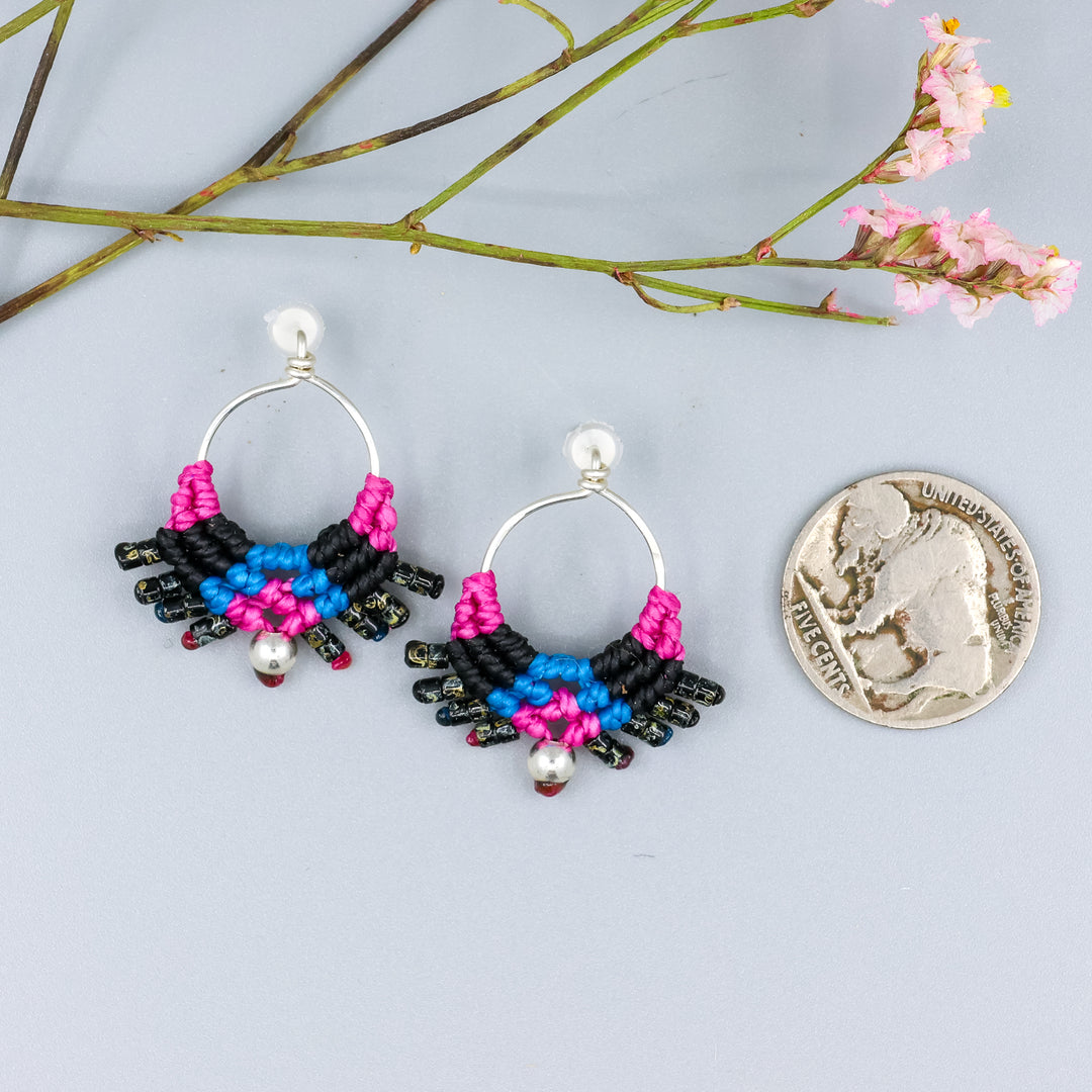 handmade sterling silver macrame earrings in bright pink, blue, and black design with a nickel for size comparison
