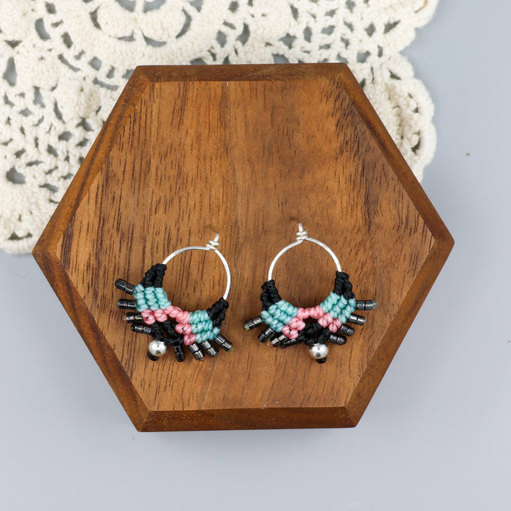 sterling silver macrame stud drop earrings with black, blue, and pink on a wood block