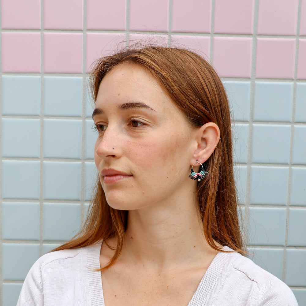 handmade sterling silver macrame earrings worn on a model