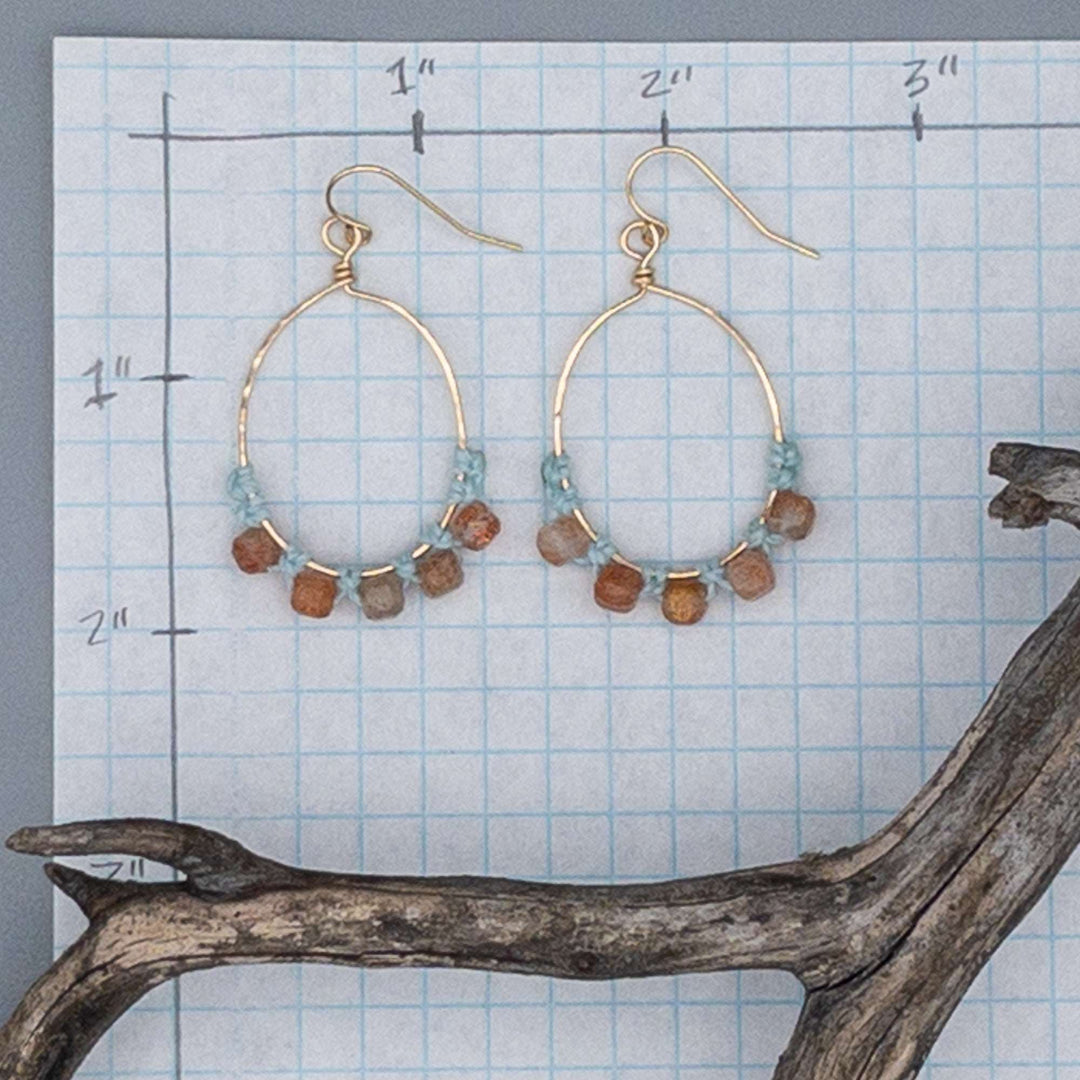 sunstone hoop earrings in 14k gold fill shown on graph paper for size comparison