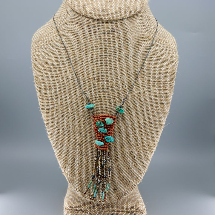 handmade macrame necklace with turquoise and seed beads on mannequin