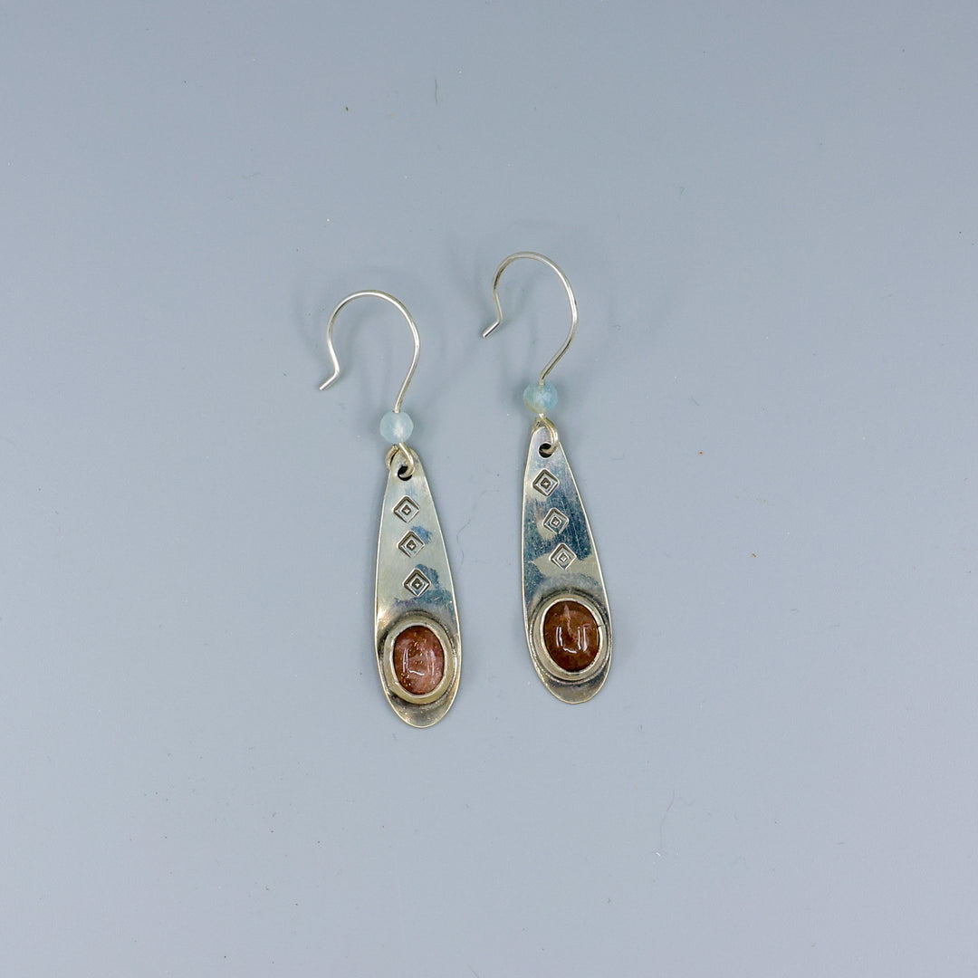 handmade silver sunstone one of a kind earrings on a gray background