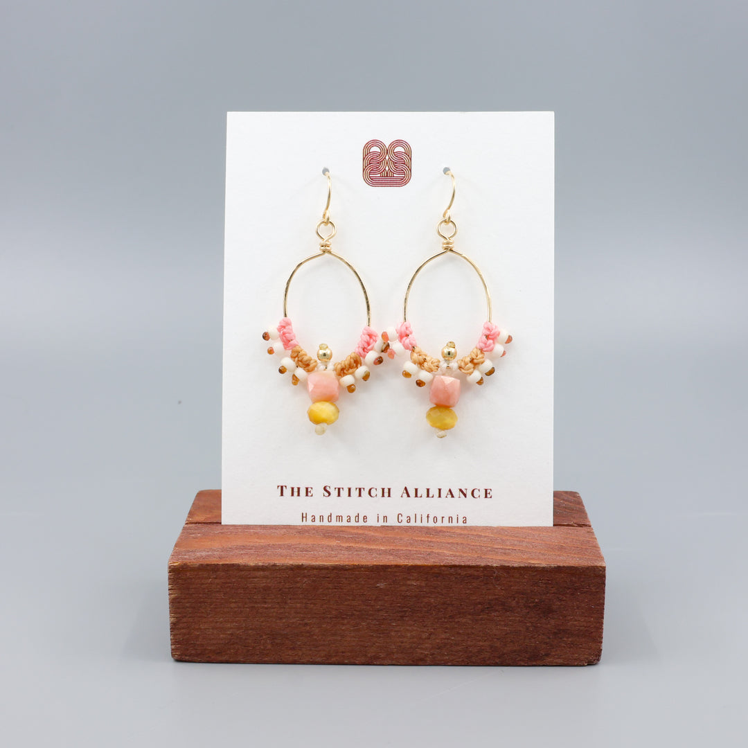 pink opal and golden tiger's eye gold macrame hoop earrings on a white card