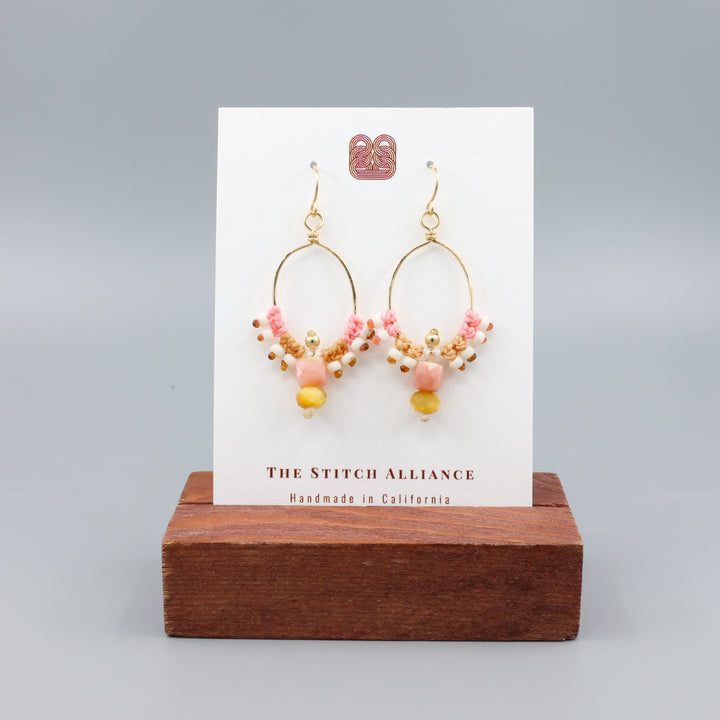 pink opal and golden tiger's eye gold macrame hoop earrings on a white card