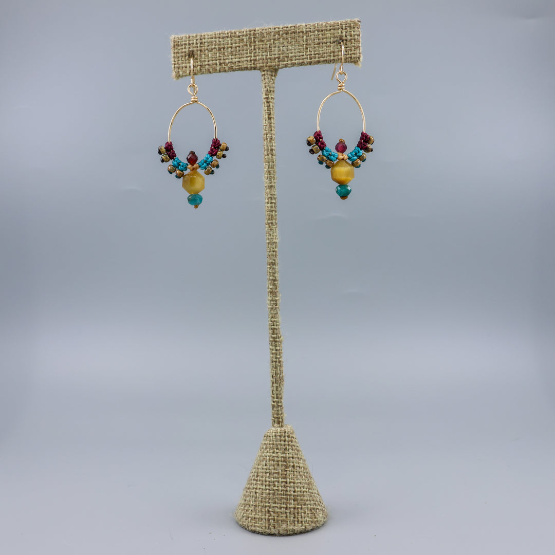 thunderbird inspired, 14k gold filled macrame hoop earrings with golden tiger's eye, blue apatite, and garnet beads
