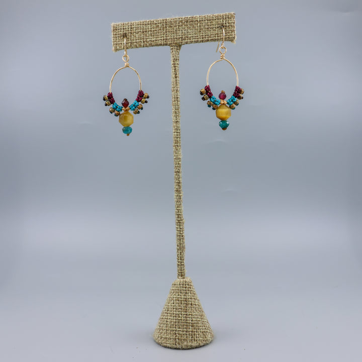 thunderbird inspired, 14k gold filled macrame hoop earrings with golden tiger's eye, blue apatite, and garnet beads