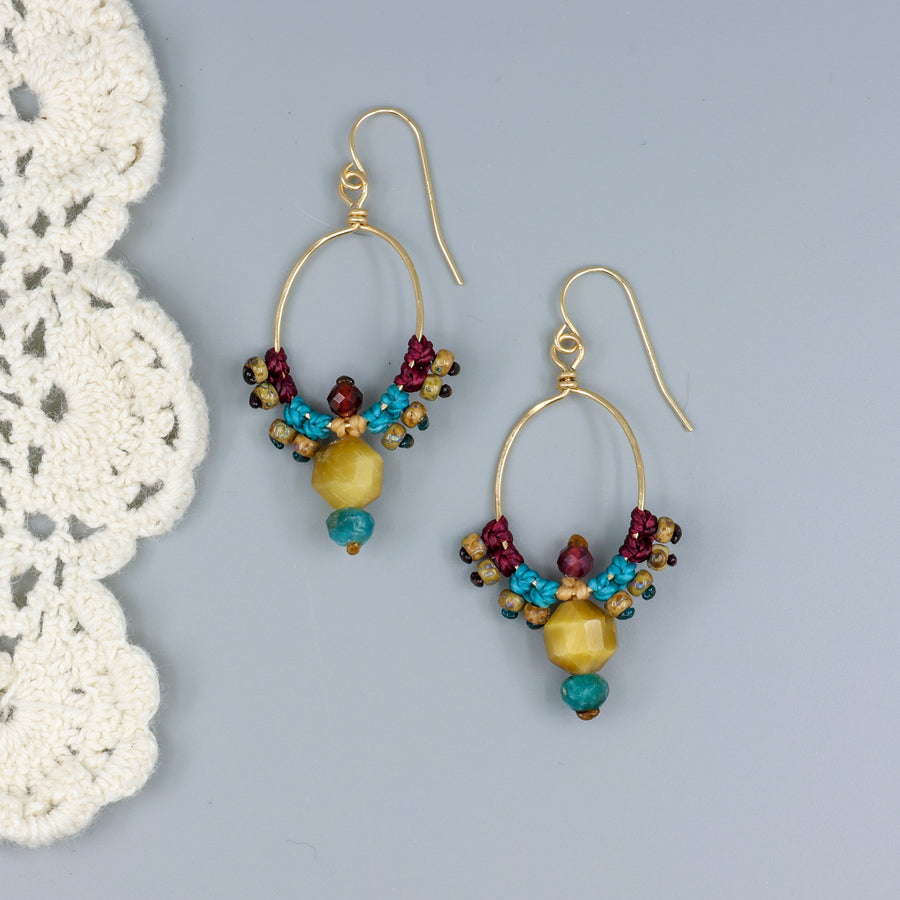 handmade thunderbird inspired, 14k gold filled macrame hoop earrings with golden tiger's eye, blue apatite, and garnet beads