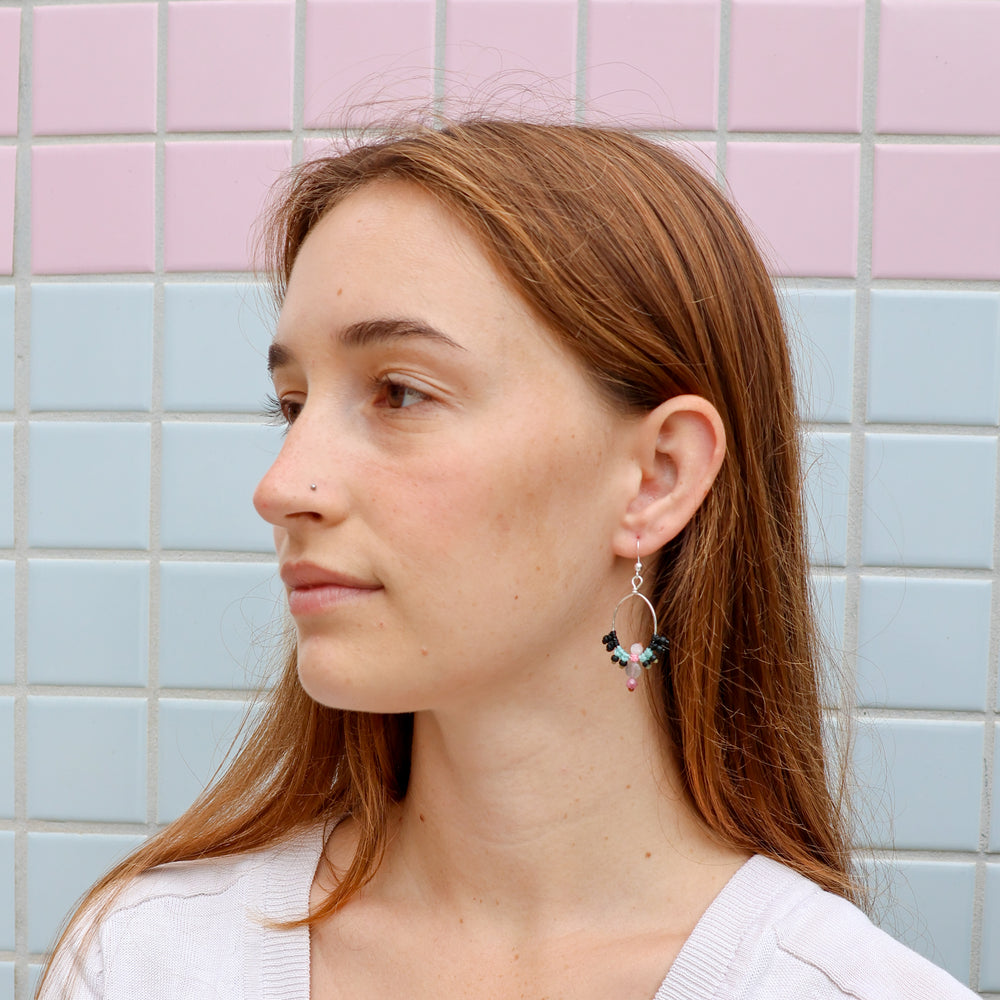 handmade macrame earrings in sterling silver with labradorite beads worn on a model