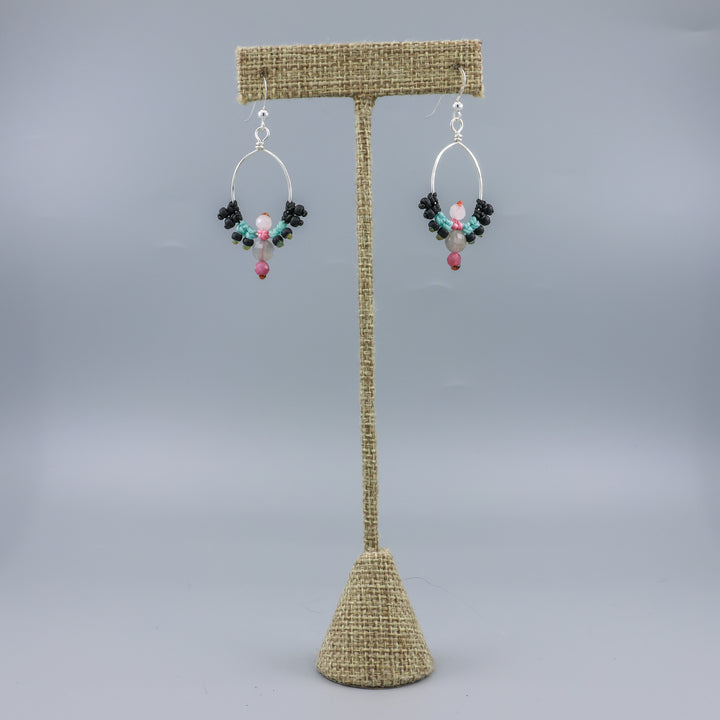 handmade sterling silver macrame hoop earrings with labradorite, tourmaline, and moonstone beads on a linen hanger