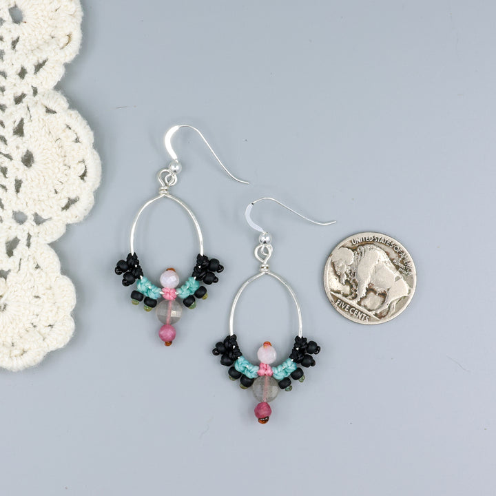 handmade sterling silver macrame hoop earrings with labradorite, tourmaline, and moonstone beads with a nickel for size comparison