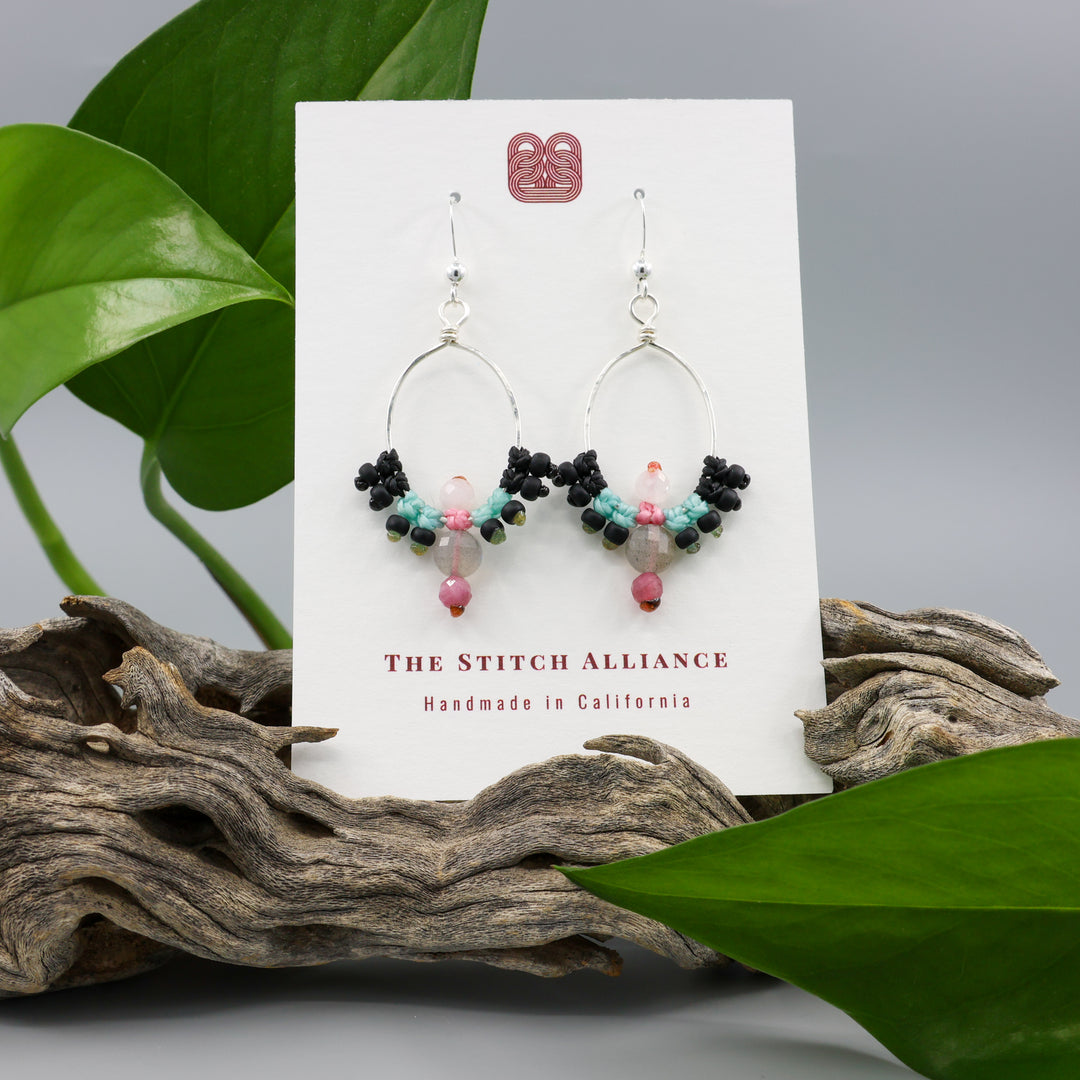 handmade sterling silver macrame hoop earrings with labradorite, tourmaline, and moonstone beads on a white card