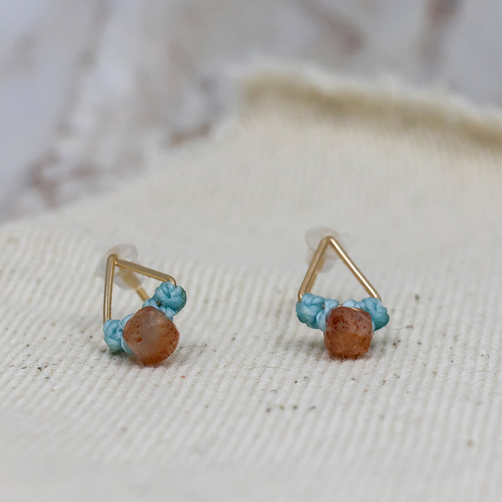 close up of 14k gold fill and sunstone stud earrings