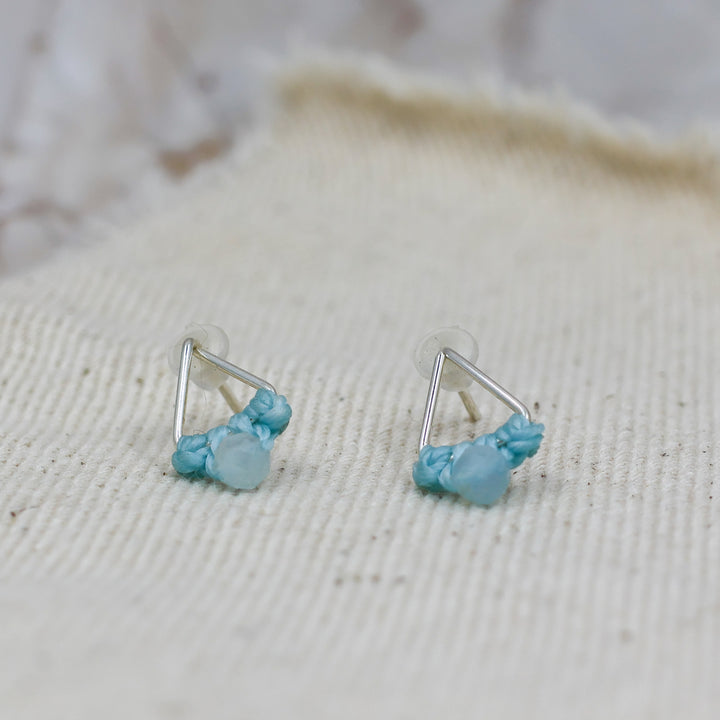 close up of triangle sterling silver aquamarine stud earrings