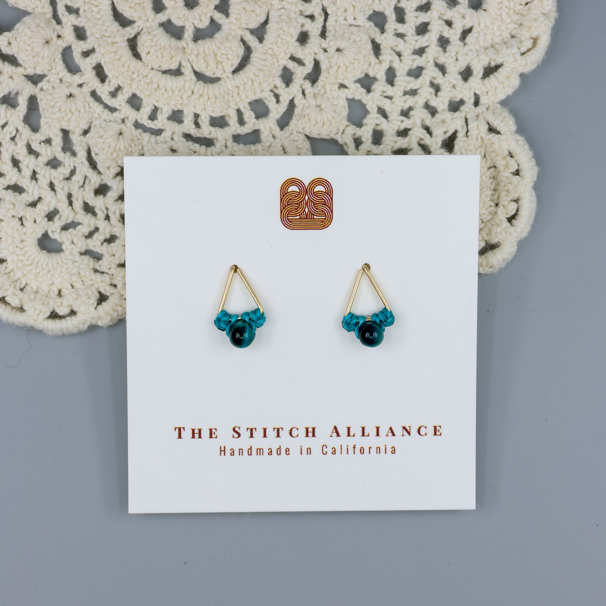 handmade blue tiger's eye triangle stud earrings in gold fill wire on a white display card