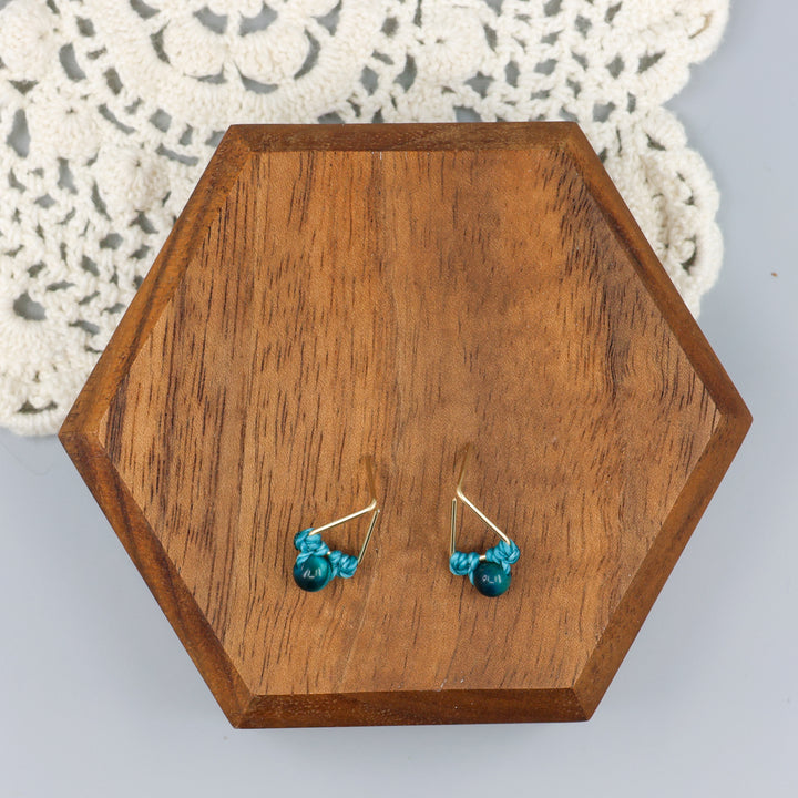 handmade blue tiger's eye triangle stud earrings in gold fill wire overhead view