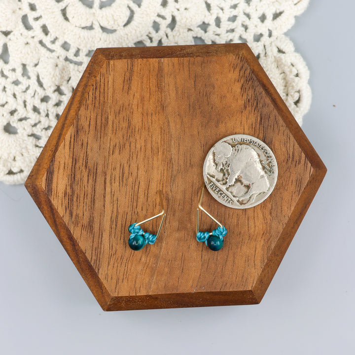 handmade blue tiger's eye triangle stud earrings in gold fill wire with a nickel for scale